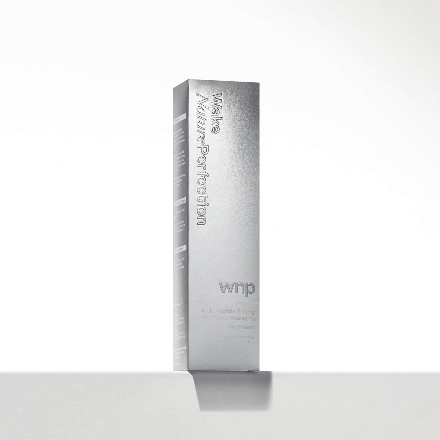 Silver skincare product box with 'wakeup' branding on a white background
