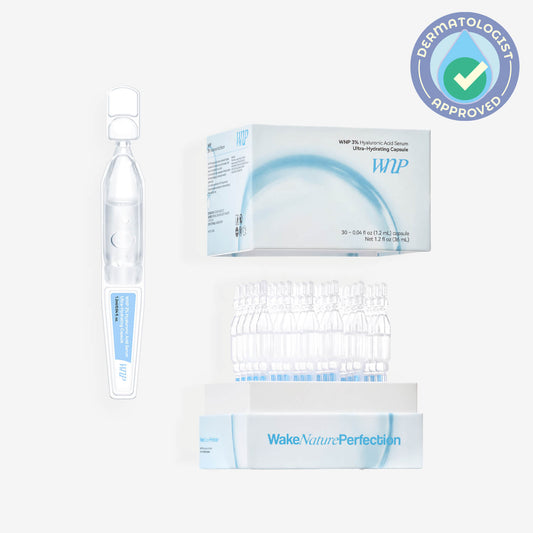 Skincare product set with bottle, box, and capsules featuring 'Wake Nature Perfection' branding.