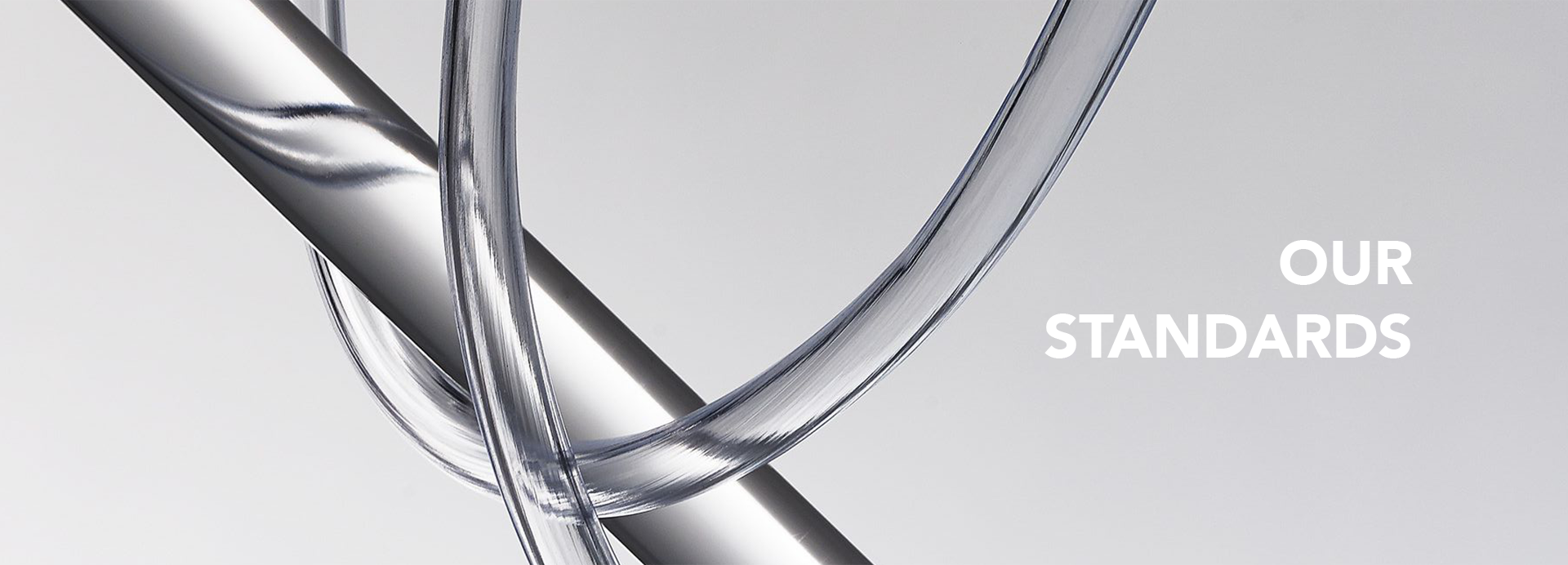 Clear glass object with 'Our Standards' text on a light gray background